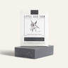 A detoxifying Activated Charcoal Bar from Little Seed Farm sits in front of its packaging, labeled with the brand and a sketch of a goat.