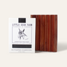 The Little Seed Farm Soap Bar + Dish Set features a handmade charcoal milk soap with a goat illustration and “Handmade in Tennessee” label, paired with a grooved cedar soap dish.