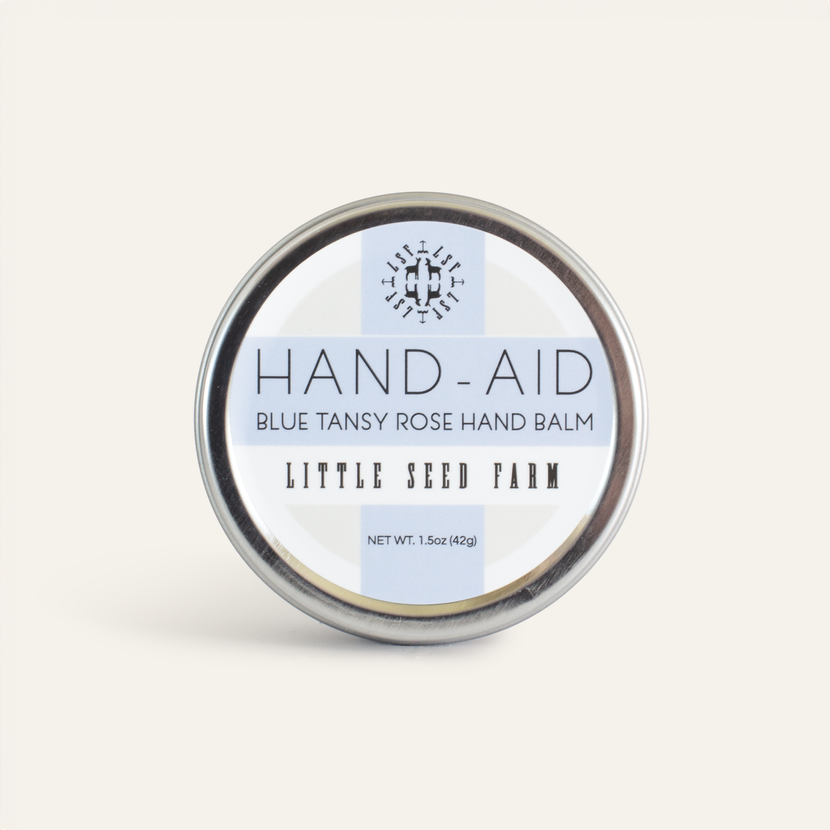 Blue Tansy Rose Hand‑Aid Healing Hand Balm featuring a crisp floral scent of delicate rose and calming blue tansy, crafted with organic shea butter, hemp seed oil, and crafted with antioxidant-rich botanicals to deeply soothe dry, cracked hands.