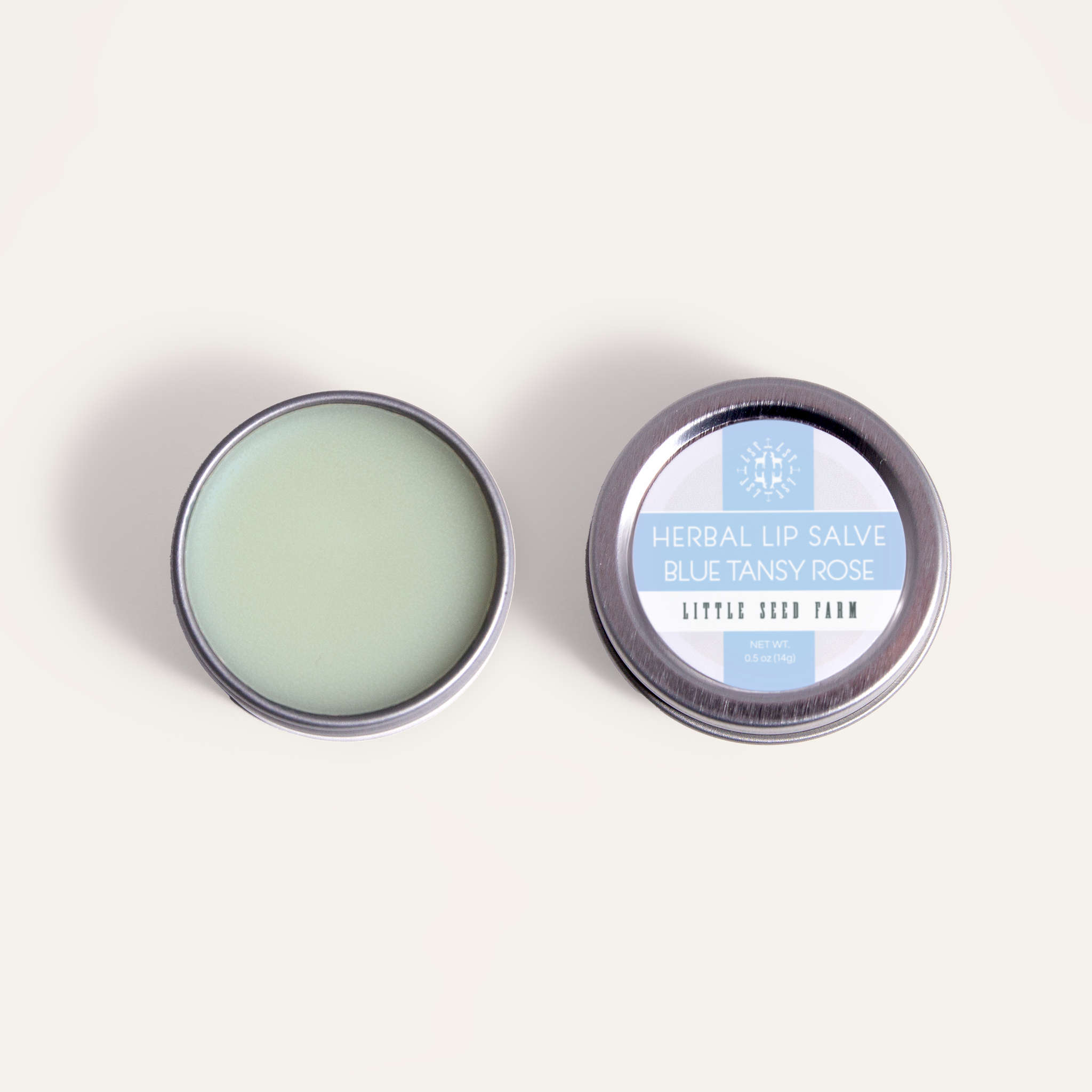 Little Seed Farm Blue Tansy Rose Lip Salve in a 0.5 oz tin, featuring organic shea butter, sweet almond oil, and herbally infused coconut oil with blue tansy and rose essential oils to soothe, hydrate, and protect lips naturally.