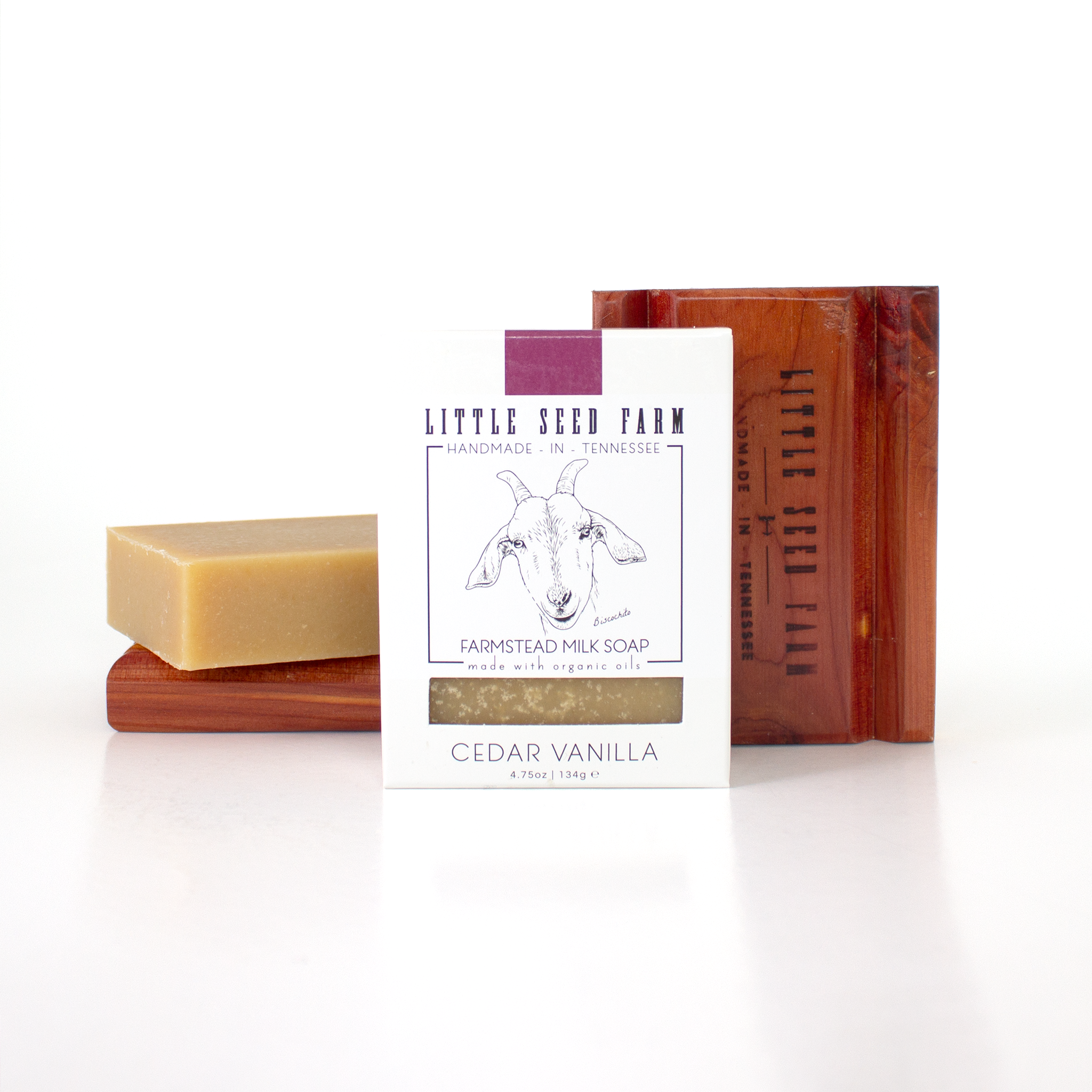 A Little Seed Farm Soap Bar + Dish Set is displayed with the soap bar on a handmade cedar dish and an unwrapped bar, all against a white background.