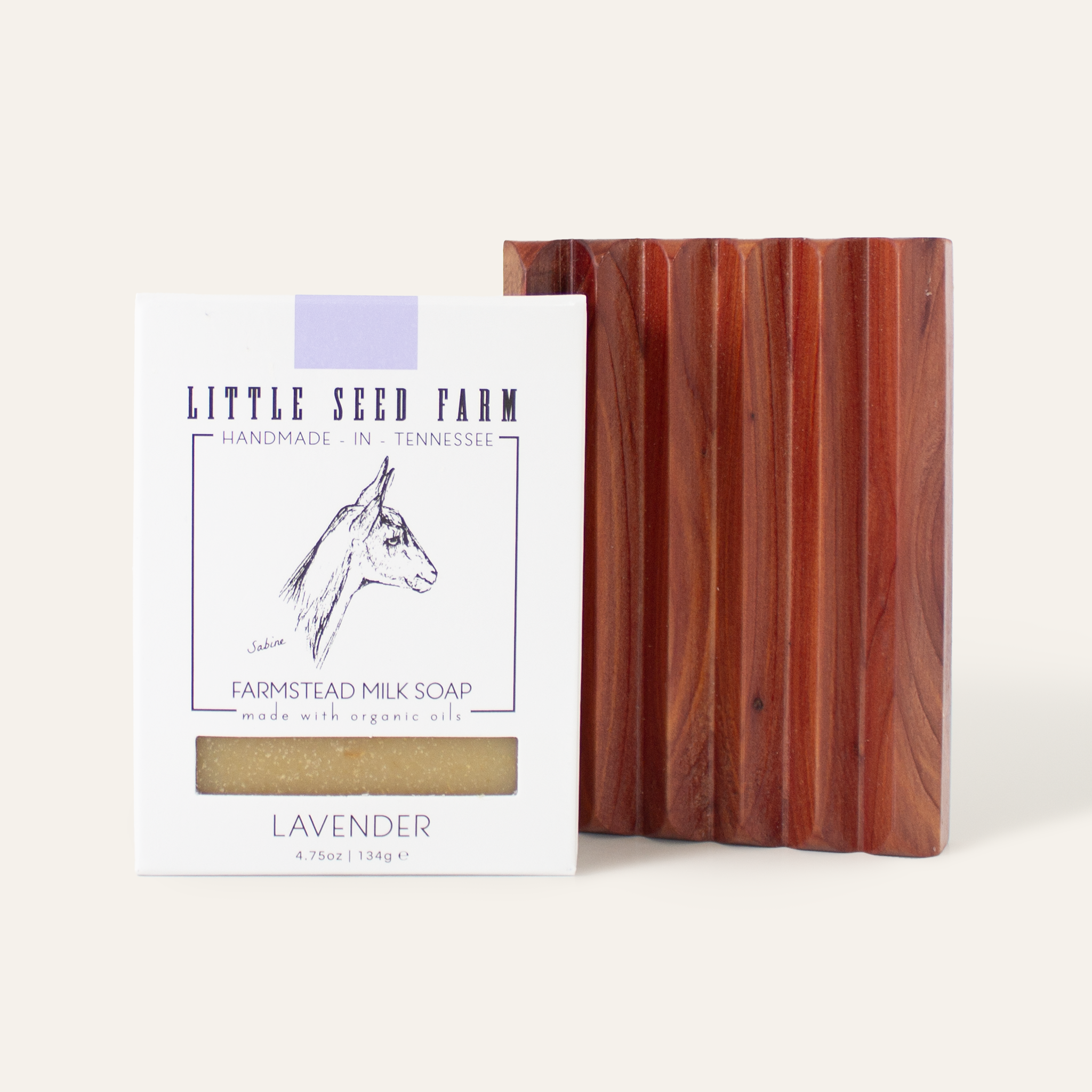 A Little Seed Farm Soap Bar + Dish Set, featuring goat milk soap with a horse illustration and a handmade cedar soap dish with vertical grooves, is displayed.