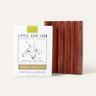 The Little Seed Farm Soap Bar + Dish Set features a handmade soap and cedar dish. The box displays a goat illustration and notes its crafted in Tennessee with organic oils.