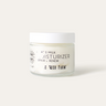 A clear upcycled glass jar with a white lid containing goat's milk moisturizer for sensitive skin. The label reads 'Goat's Milk Moisturizer Repair + Renew'.