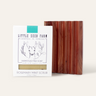 The Little Seed Farm Soap Bar + Dish Set, featuring a Farmstead Milk Soap Bar and a cedar soap dish with vertical grooves, is displayed against a light background.