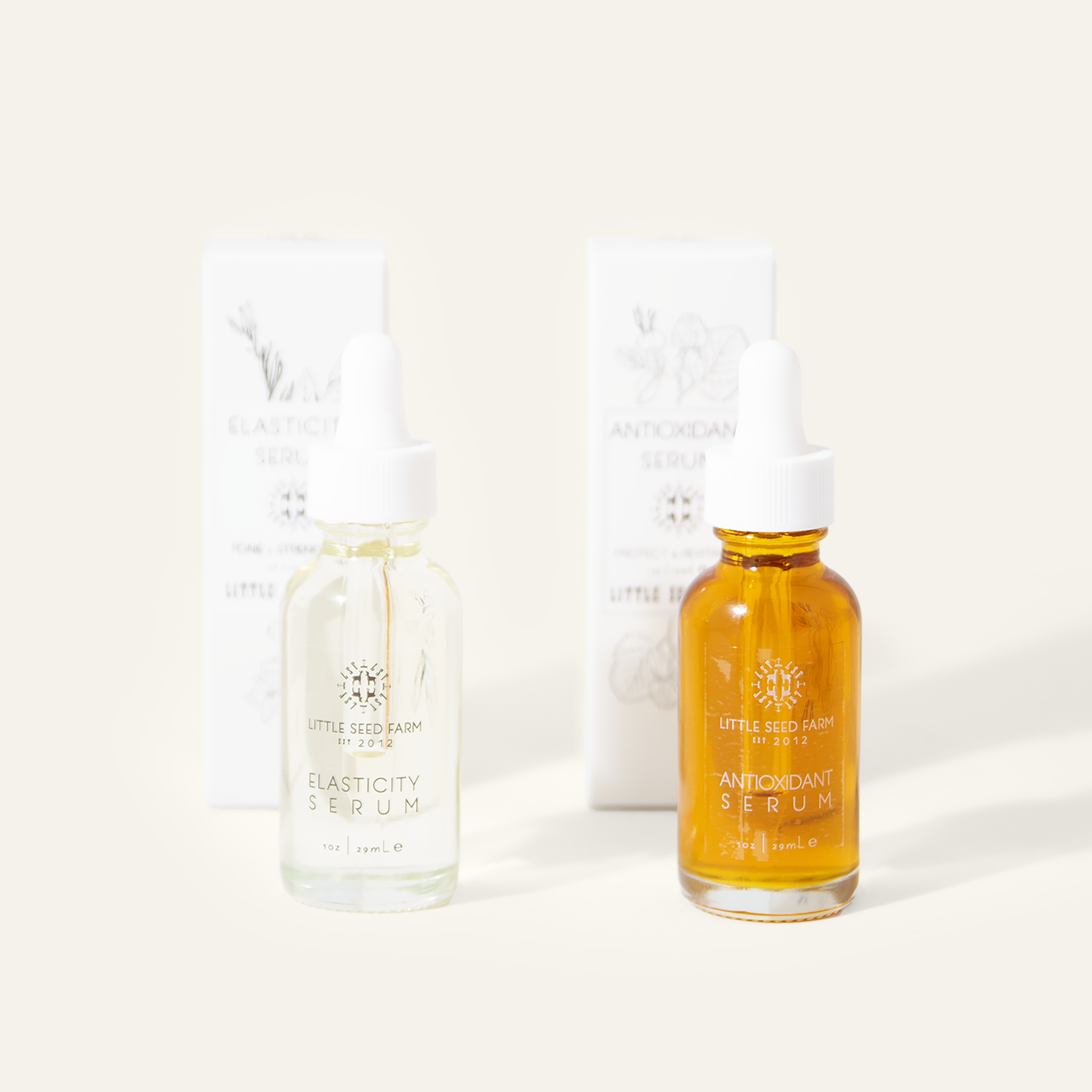 Little Seed Farm Serum Duo featuring two 1 oz bottles—Elasticity Serum with hazelnut and rosemary oils for skin firmness and reduced fine lines, and Antioxidant Serum with CoQ10, rosehip, sea buckthorn, raspberry seed, calendula, and vitamin E for environmental protection and radiant hydration