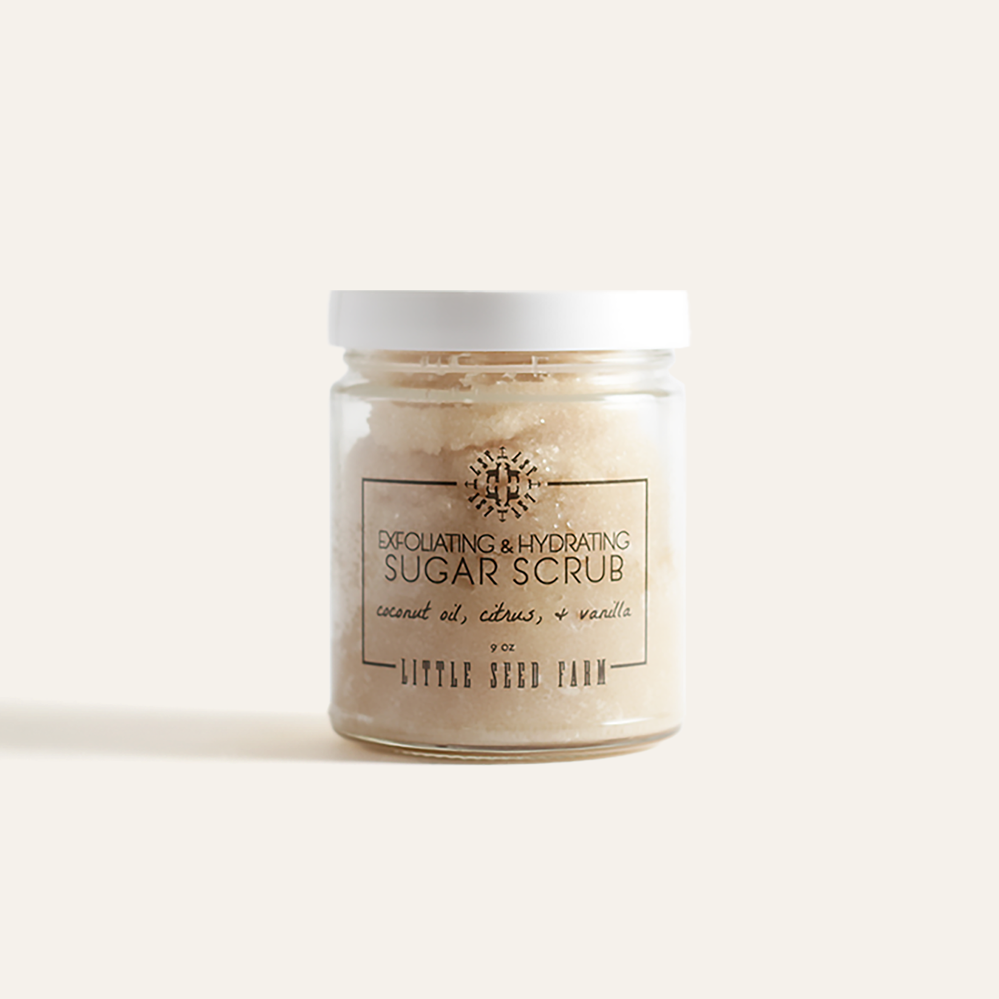 Organic Sugar Scrub in a refillable glass jar with fair-trade sugar and nourishing oils designed to exfoliate, hydrate, and uplift the skin with a clean, tropical-vanilla scent.