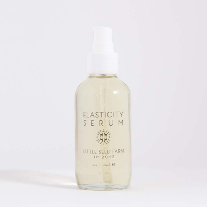 Usage instructions recommending massaging 2–3 drops into damp skin after cleansing for both face and body to support elasticity, fade stretch marks, and firm sagging areas