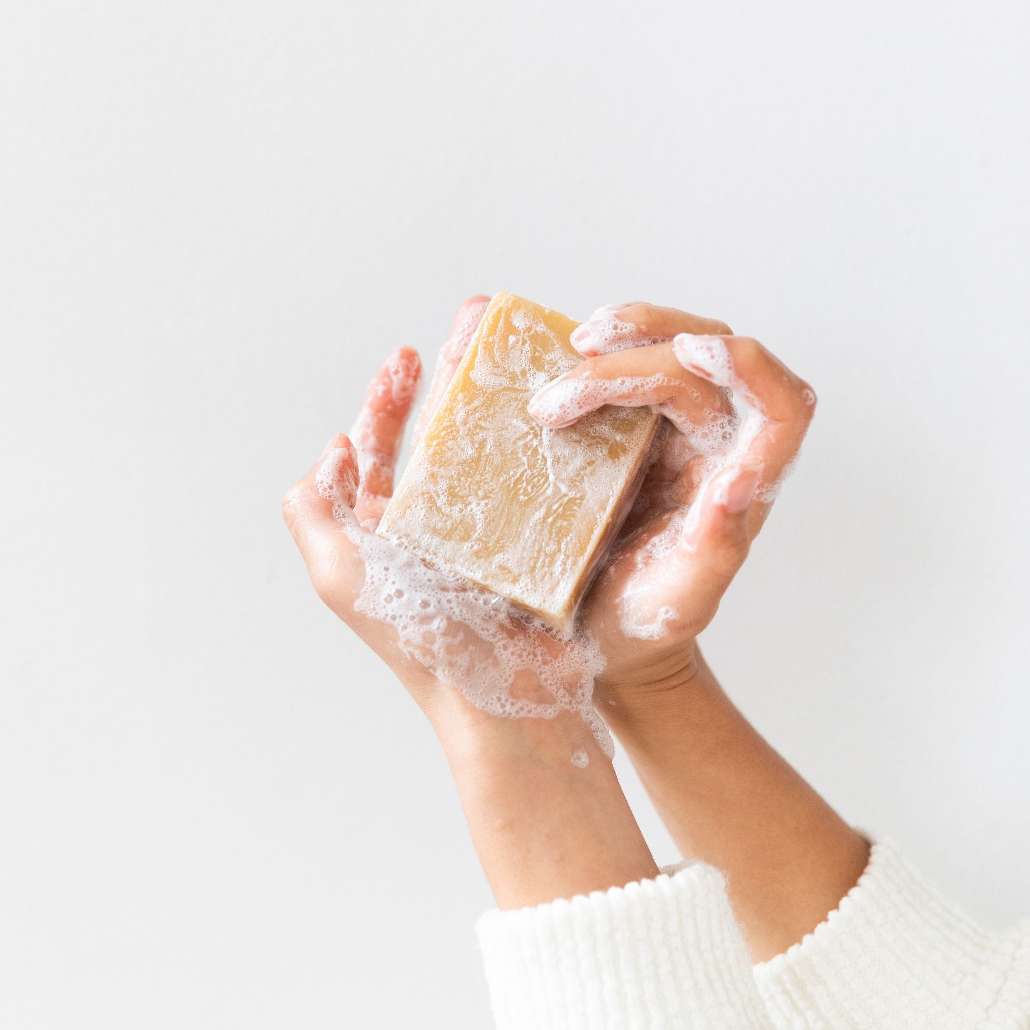 Lathered Grapefruit Lemon goat’s milk soap creating bright, moisturizing foam infused with organic turmeric and citrus essential oils for gentle facial and body cleansing.