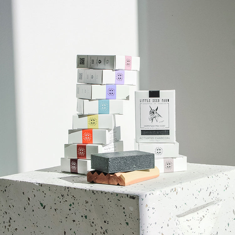 Collection of Little Seed Farm Farmstead Milk Soap varieties including Activated Charcoal, Blue Tansy Rose, Geranium Rose, Grapefruit Lemon, Lavender, Matcha & Argan, and more—all handcrafted with goat’s milk and natural oils for gentle skin nourishment