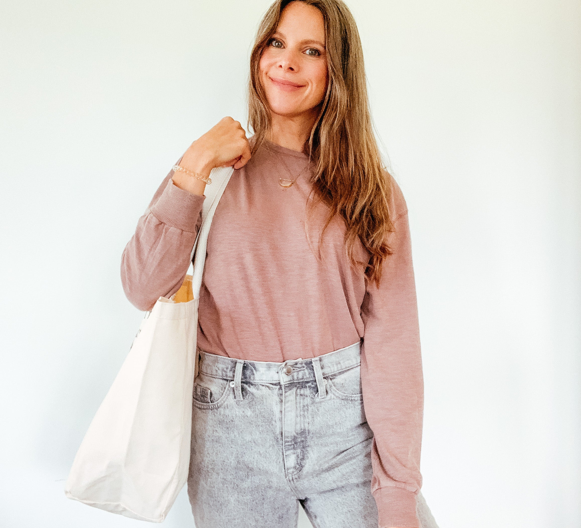 A lifestyle shot of the tote being carried by a person, demonstrating its practical use and stylish appearance.