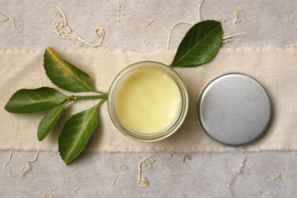 Little Seed Farm Baby Diaper Balm in a glass jar, a gentle yet potent salve made with herbally infused coconut oil, shea butter, and organic healing botanicals to soothe and protect delicate baby skin.