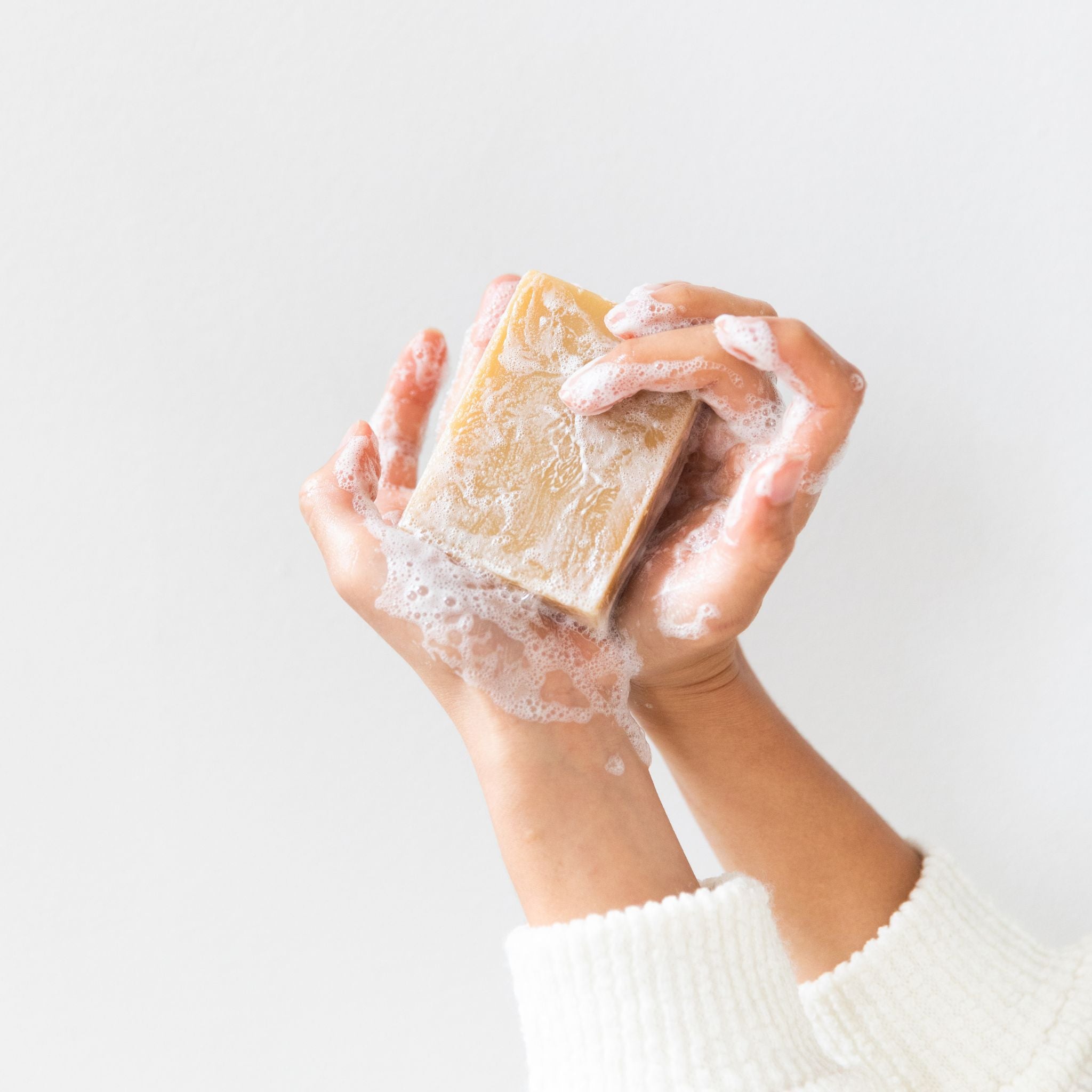 Lathering Orange Vetiver goat’s milk soap with rich foam infused with antioxidant-rich goat’s milk and citrusy-earthy essential oils to soothe nerves and hydrate dry or irritated skin.