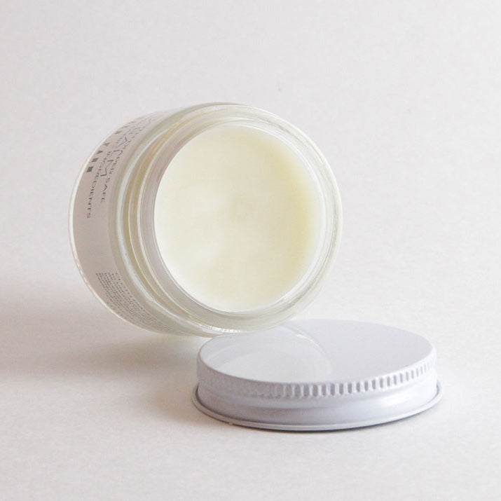 Open jar of Baby Diaper Balm revealing a creamy, balm texture rich in nourishing shea butter and beeswax, formulated to create a breathable barrier against irritation while remaining cloth-diaper safe.
