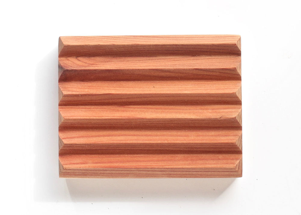 Sustainably crafted cedar soap dish designed to elevate and extend the life of bar soap by allowing proper drainage and airflow.