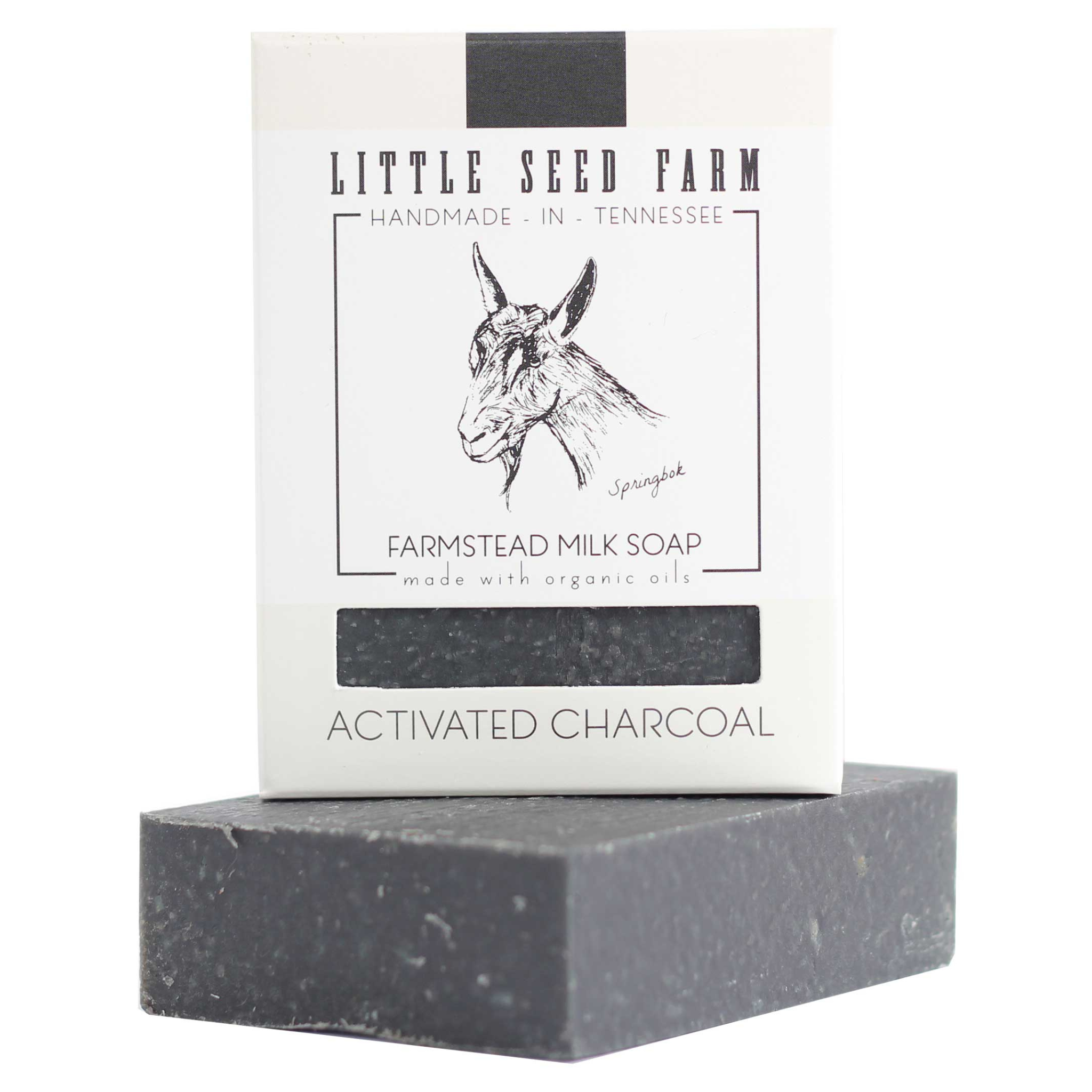 The Activated Charcoal Bar by Little Seed Farm sits in front of its packaging, which displays a goat illustration and the words “Little Seed Farm, Handmade in Tennessee.
