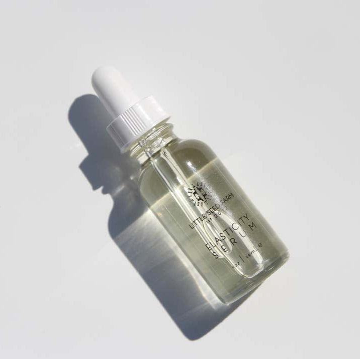 Little Seed Farm Hazelnut Rosemary Elasticity Serum formulated with virgin hazelnut oil and an organic essential oil blend to moisturize, tone, enhance skin elasticity, reduce fine lines and hyperpigmentation, and leave a glowing finish