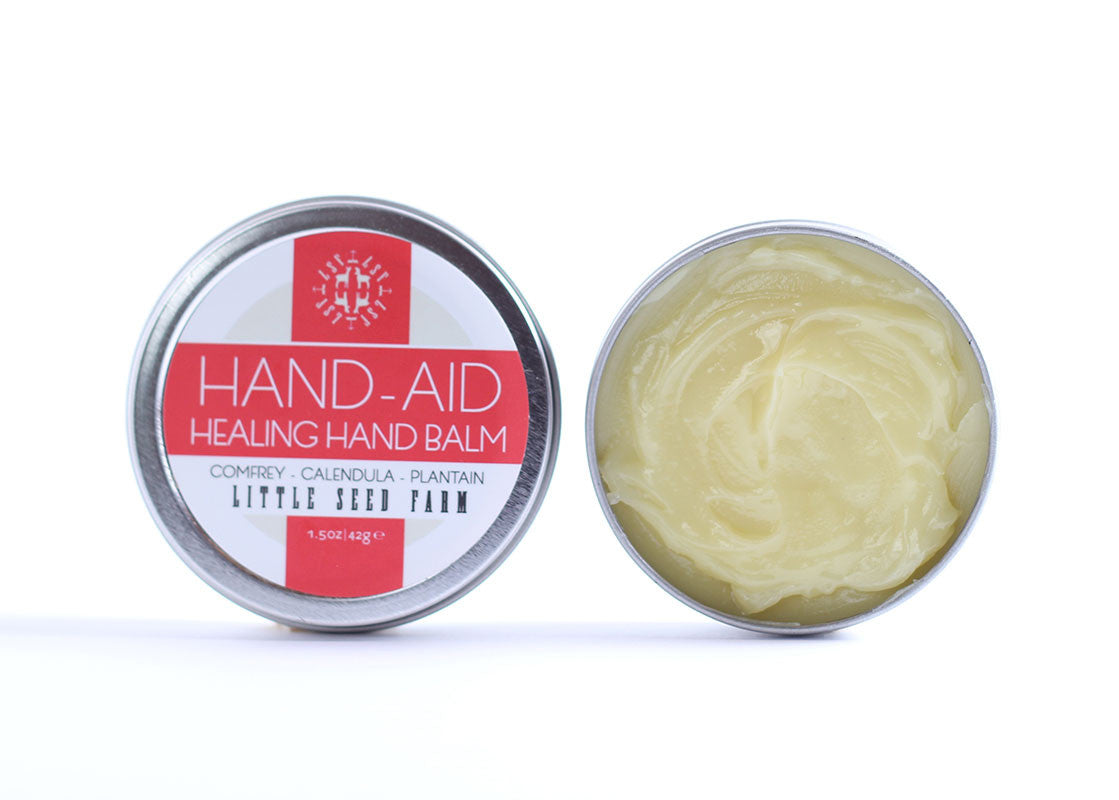 Little Seed Farm Original Hand‑Aid Healing Hand Balm, a potent organic salve infused with lemongrass, mint, and rosemary essential oils to soothe dry, cracked hands and cuticles”—crafted with herbally infused organic coconut oil, shea butter, beeswax, hemp seed oil and certified organic ingredients