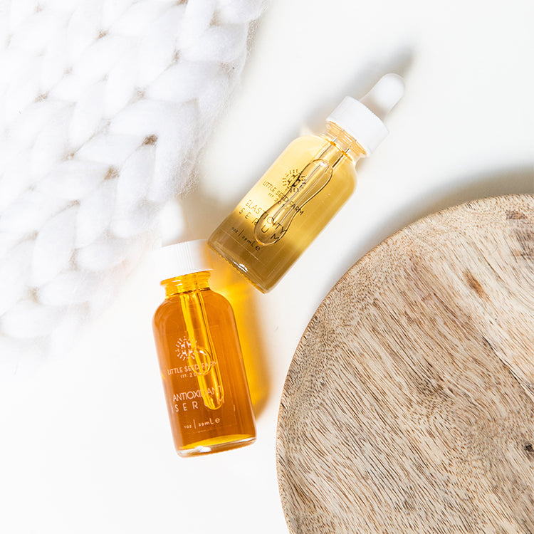 Product information card listing key ingredients for Elasticity Serum and Antioxidant Serum, emphasizing collagen‑boosting botanicals, phytonutrient antioxidants, and essential fatty acids for revitalized, firm skin