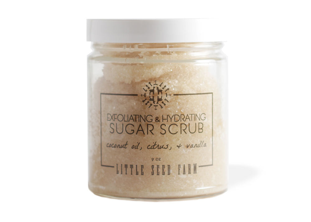 Organic Sugar Scrub in a refillable glass jar with fair-trade sugar and nourishing oils designed to exfoliate, hydrate, and uplift the skin with a clean, tropical-vanilla scent.