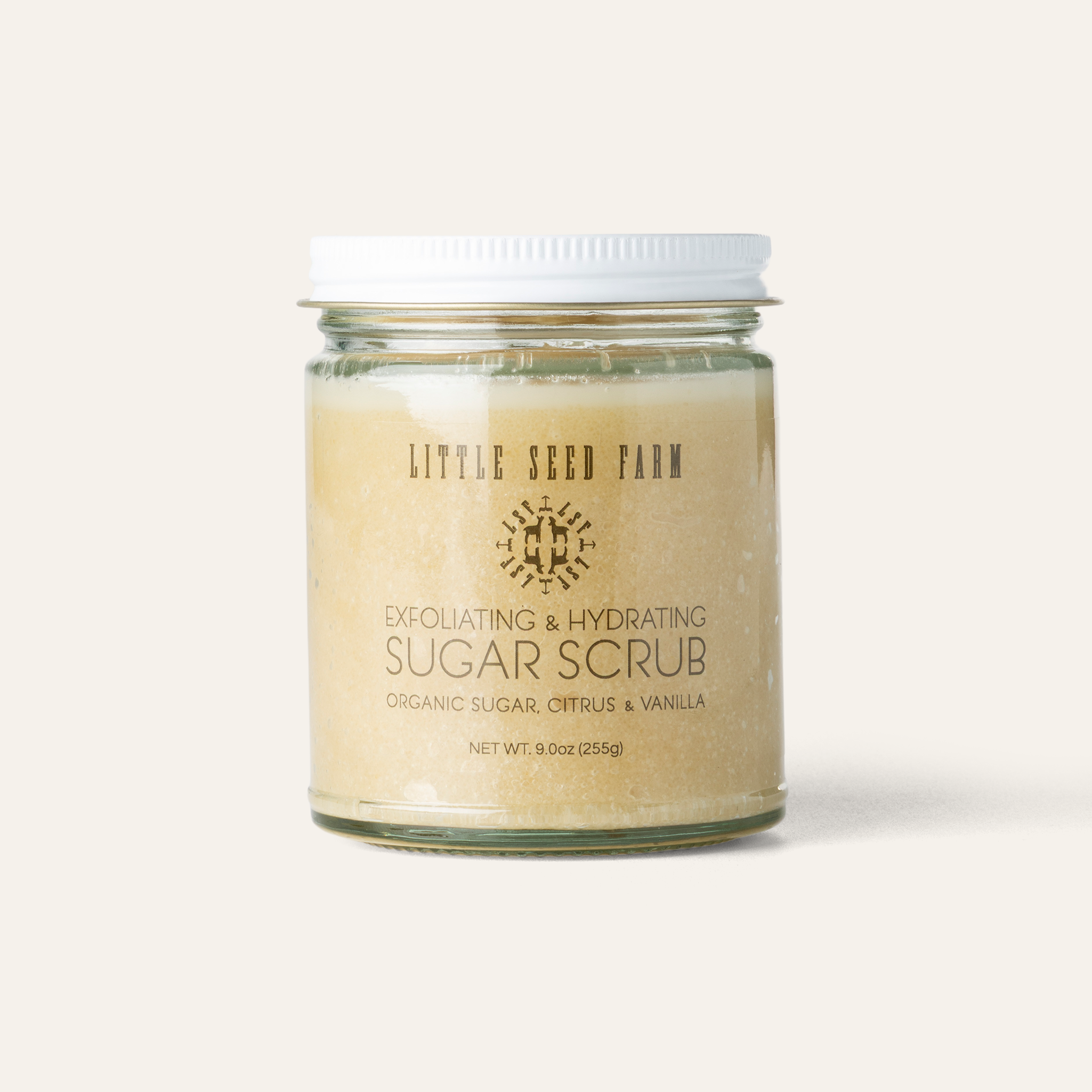 Organic Sugar Scrub in a refillable glass jar with fair-trade sugar and nourishing oils designed to exfoliate, hydrate, and uplift the skin with a clean, tropical-vanilla scent.